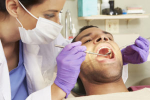 Man getting a teeth cleaning as part of his oral care at Wellington Smiles in Wellington FL.